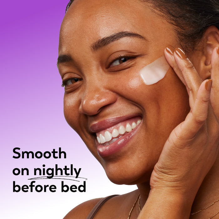 Woman applying cream to her face with a purple background and text about nightly use.
