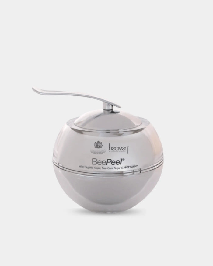 Silver spherical shaped skincare jar for the heaven bee peel on a white background.