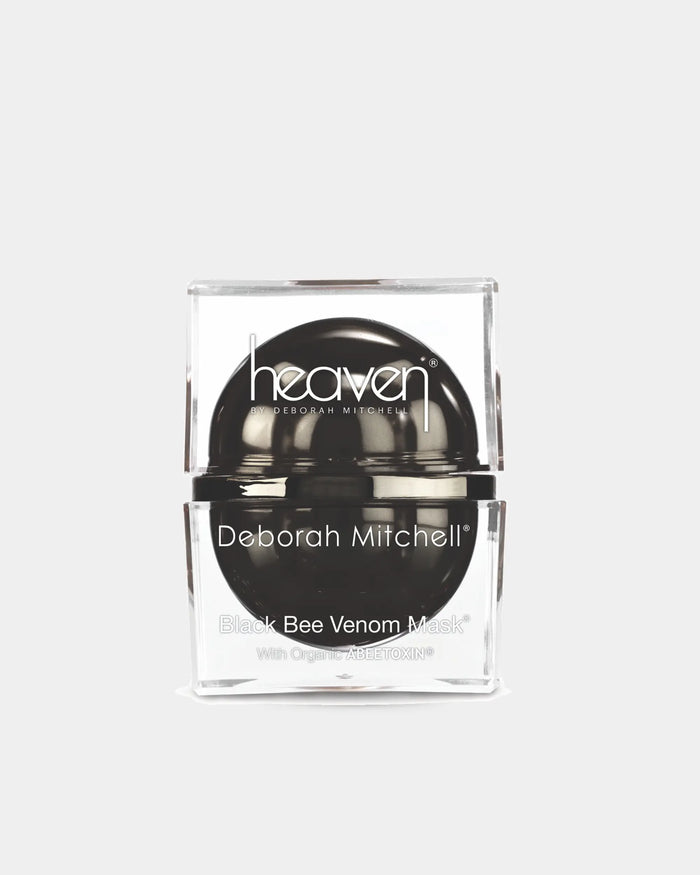 Black bee venom mask in a clear container with 'heaven' branding on a white background