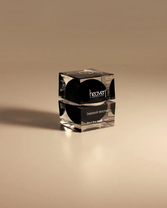 Cosmetic jar with black lid on a beige background