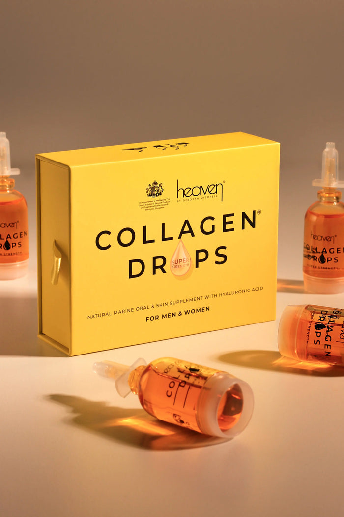 Yellow box of Heaven Collagen Drops with several amber vials, some upright, one lying down.