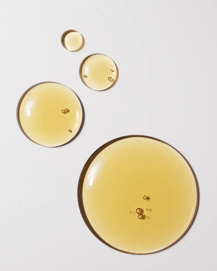 Four yellow droplets on a light gray background