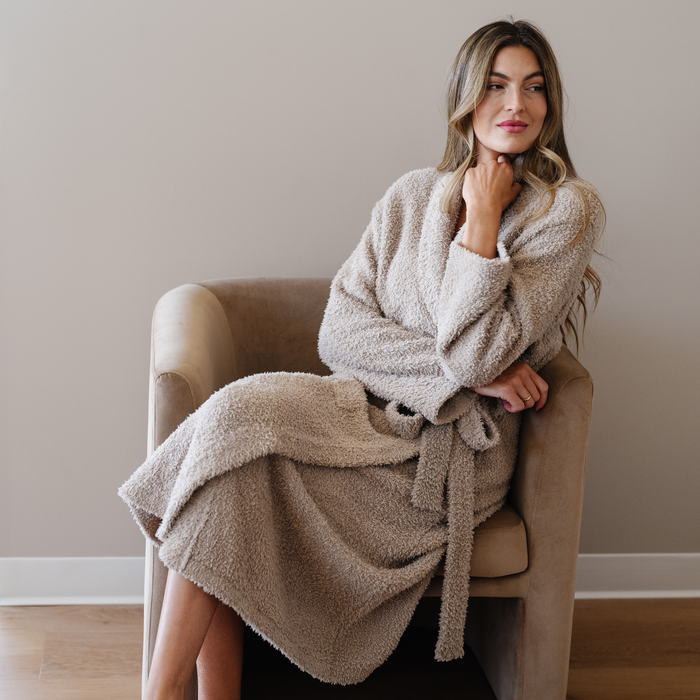 Woman wearing taupe bamboni robe sitting in chair.
