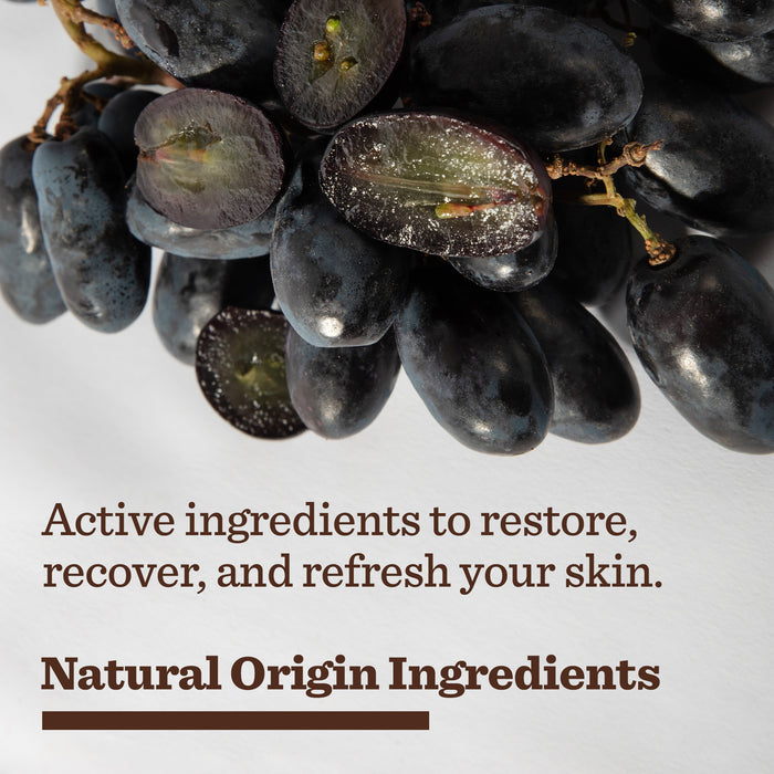 A close-up of dark purple grapes, one sliced open, beside text: Restore, recover, and refresh your skin. Experience our End of Day Recovery Trio with natural origin ingredients.