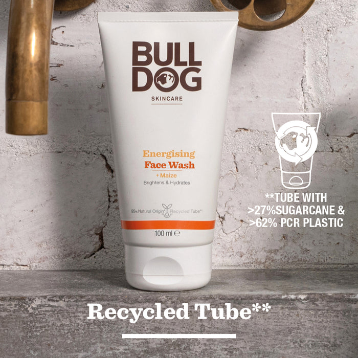 A tube of Energising Face Wash stands on wood, made with over 27% sugarcane, 62% recycled plastic, and natural origin ingredients to revitalise tired skin. Recycled Tube** appears at the bottom.