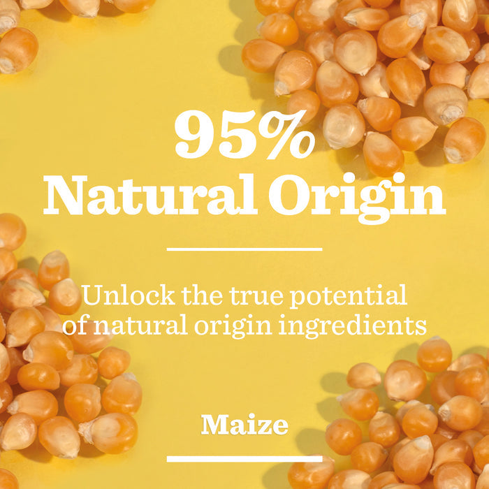 Yellow and orange maize kernels are scattered on a yellow background. Bold white text in the center reads “95% Natural Origin”, with smaller text below stating, “Unlock the true potential of brightening properties. Energising Moisturiser.”.