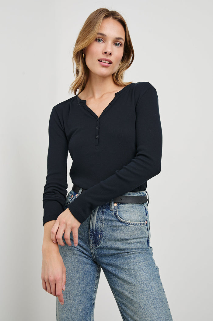 Essential Long-Sleeve Finely Ribbed Henley, with a V Neck and a Placket with Buttons in Black Colorway - Front Tucked View Featured on Model