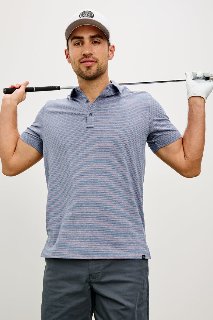 Merced Golf Polo in TENCEL™ Poly Blend With Collar, Quarter Placket, Short Sleeves, and Classic Fit in Hibiscus Mirage Stripe Colorway - Upper Body Front View Featured on Model