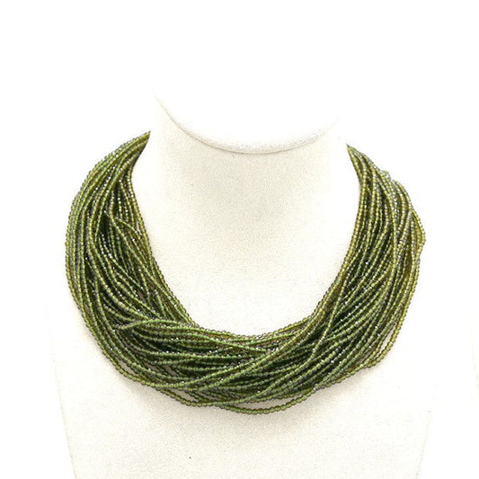 green necklace on mannequin busts 'Habana' logo.