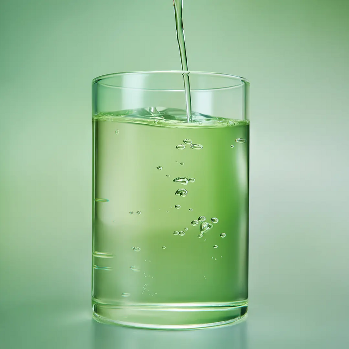 Beplain Mung Bean Cleansing Oil poured into glass showing clear lightweight oil formula with mung bean extract