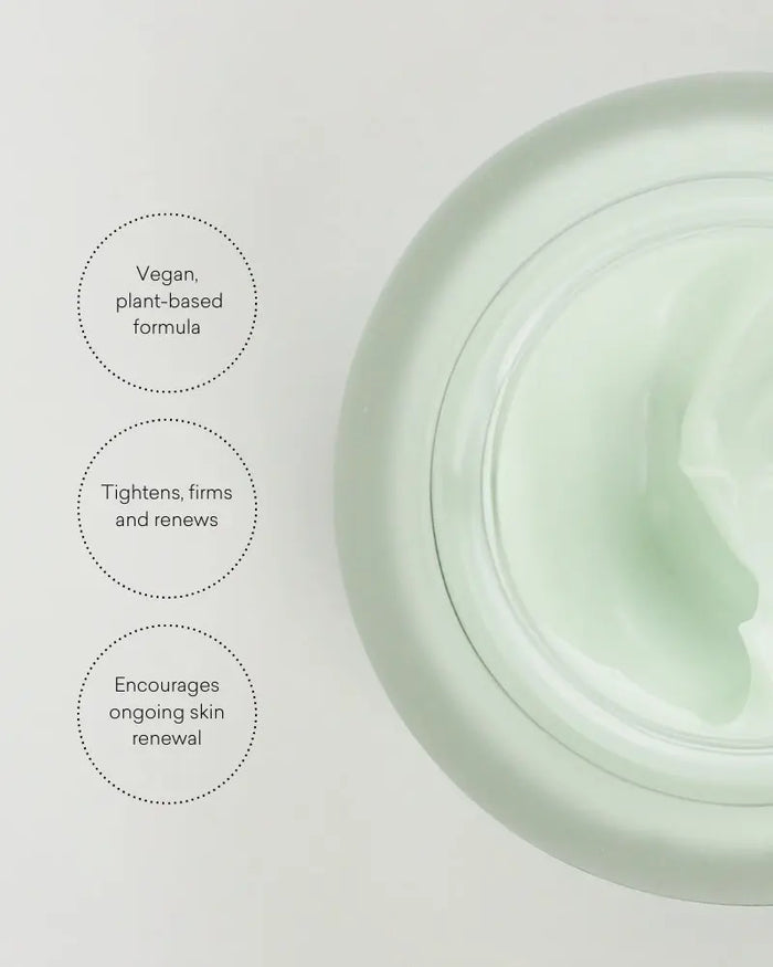 Green skincare product jar with text on a light gray background