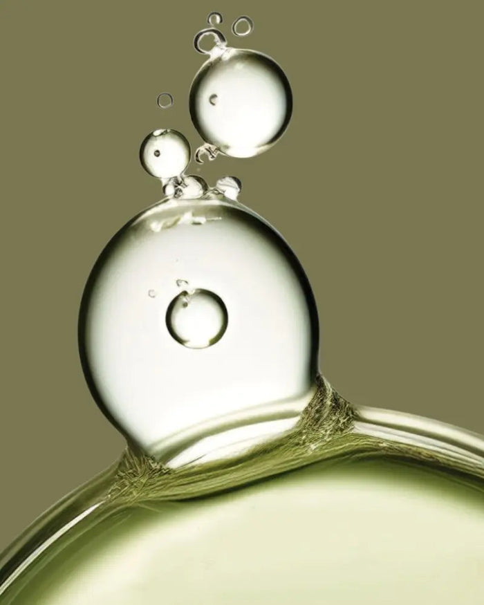 Close-up of oil droplets and bubbles on a beige background