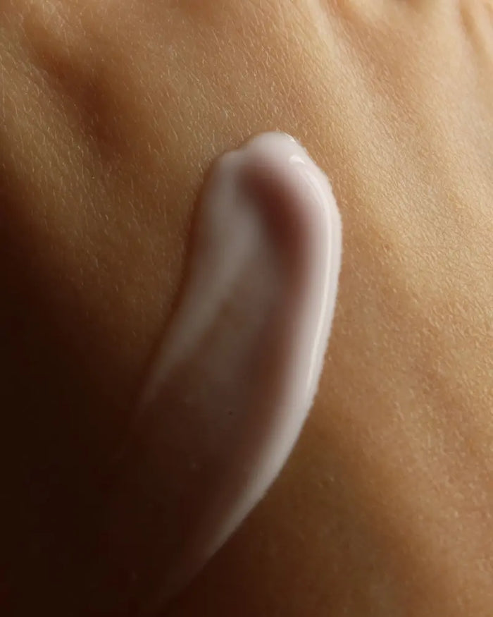 Close-up of a small amount of cream swatched on skin