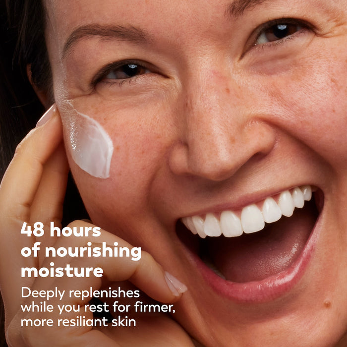 Woman applying cream to her face with a focus on skincare.