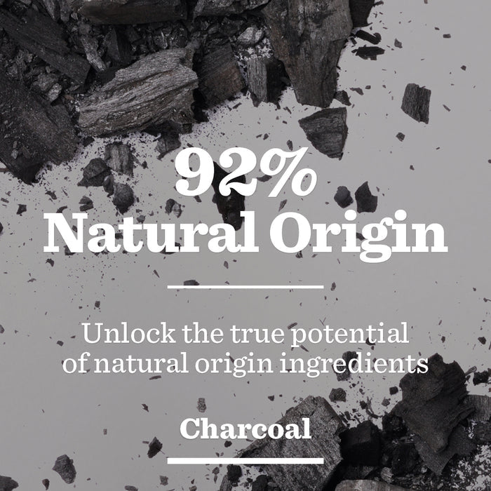 Charcoal pieces on a light background with text: 92% Natural Origin. Experience the power of natural ingredients with Oil Control Face Scrub for men.