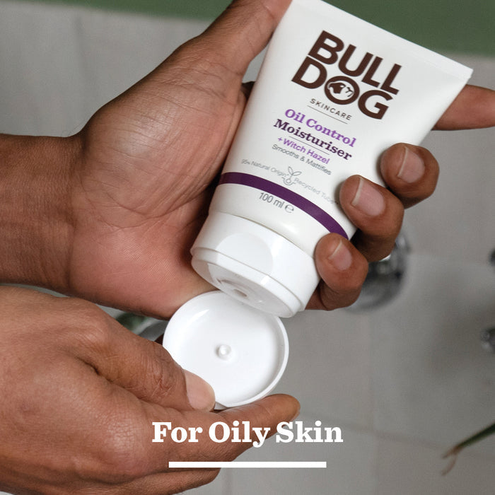 Someone holds an open tube from the Oil Control Skincare Bundle over a bathroom sink. Text at the bottom reads For Oily Skin.
