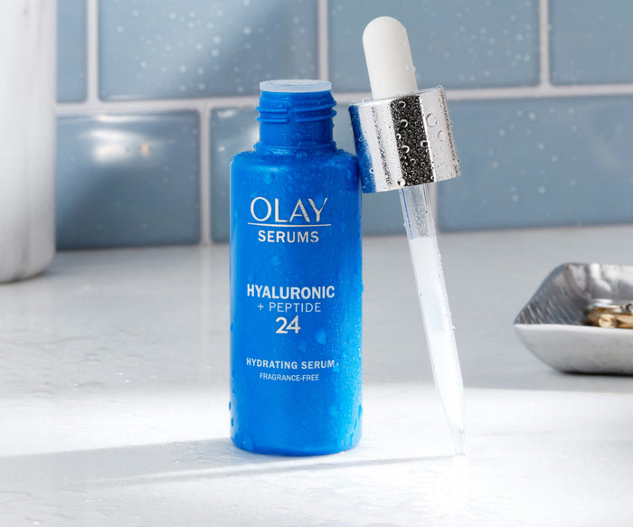 Olay serum bottle with dropper on a bathroom counter