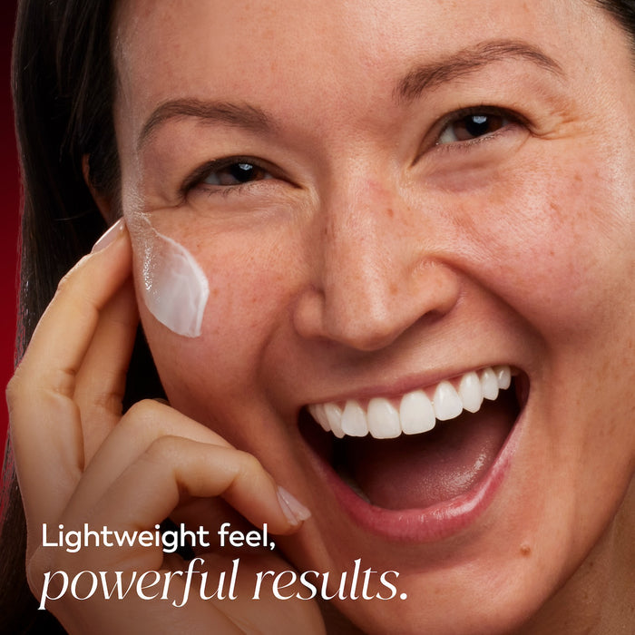 Model posing and smiling applying Olay Niacinamide Hydrating Cream to face. Lightweight feel. Powerful results.