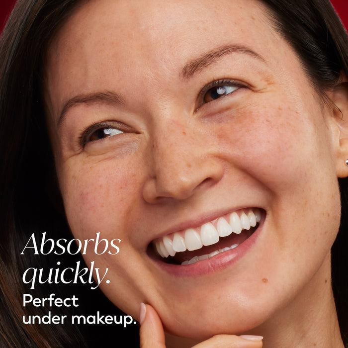 Model posing and smiling. Absorbs quickly. Perfect under makeup.
