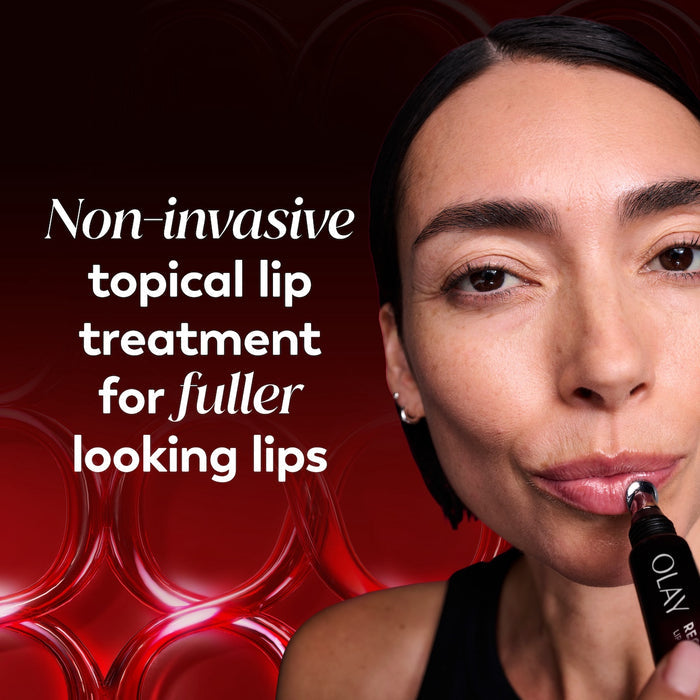 Model posing applying Regenerist Lip Plumping Treatment. Non invasive topical lip treatment for fuller looking lips