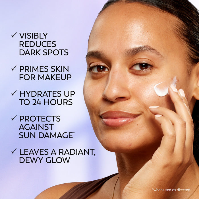 Model posing applying Olay Super Cream Mini with Sunscreen SPF 30, Ultra Lightweight SPF Face Moisturizer to face. Visibly reduces dark spots. Primes skin for makeup. hydrates up to 24 hours. Protects against sun damage. leaves a radiant dewy glow.