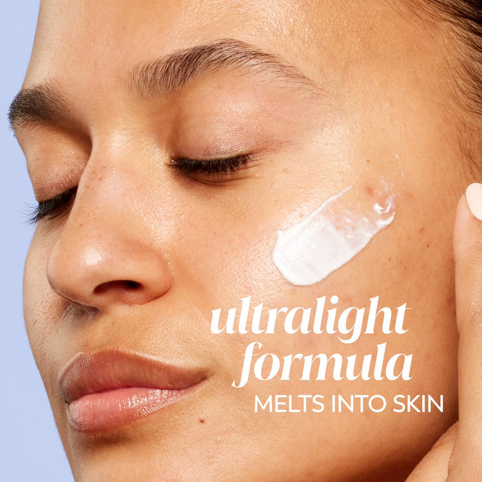 Model posing applying Olay Super Cream Mini with Sunscreen SPF 30, Ultra Lightweight SPF Face Moisturizer to face. Ultralight formula melts into skin