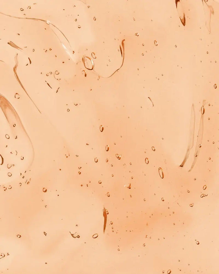 Close-up of product. Peach-colored gel texture.