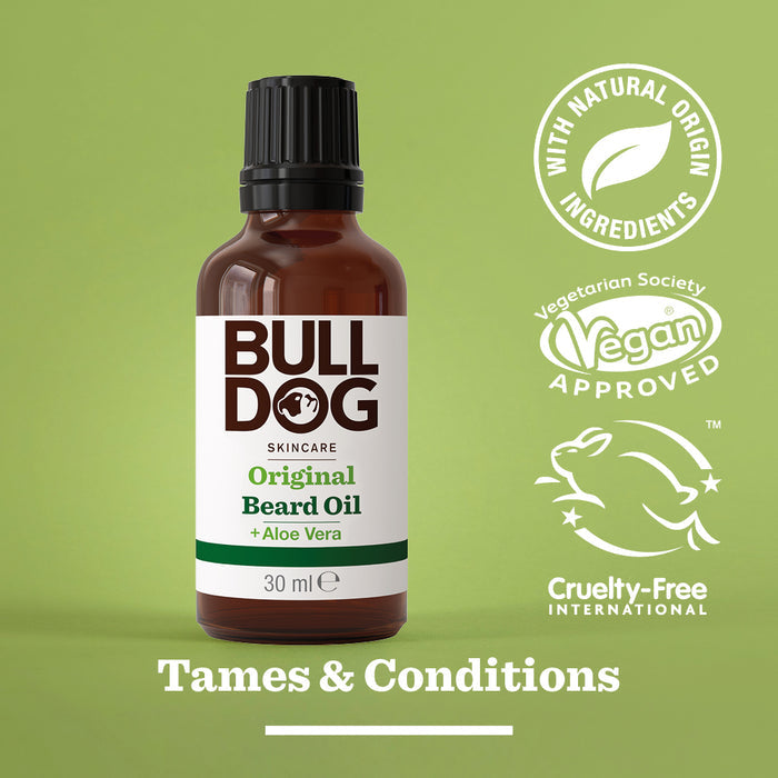 A bottle of Original Beard Oil with moisturizing Aloe Vera sits on a green background. Vegan, cruelty-free, and natural ingredient logos appear on the right. The text “Tames & Conditions” is displayed at the bottom.