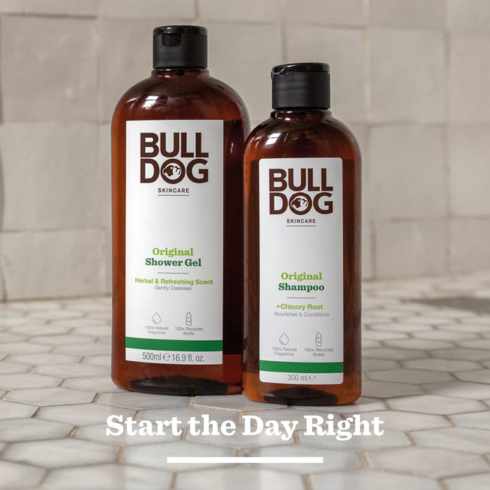 A bottle of Bulldog Skincare’s Original Shampoo stands on a tiled surface, highlighting mens hair care with natural ingredients. The text Start the Day Right is written below it.