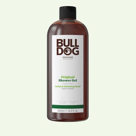 A brown bottle of Bulldog Original Shower Gel for men with a black cap. The 500ml label shows the brand name and notes its refreshing scent and natural ingredients.