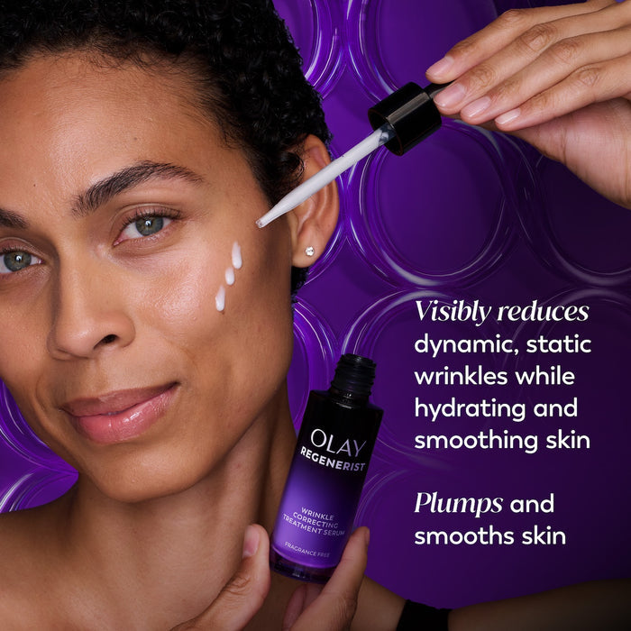 Model posing using Regenerist Wrinkle Correcting Night Treatment bottle open showing dropper to apply serum on face. Visibly reduces dynamic, static wrinkles while hydrating and smoothing skin. Plumps and smooths skin.