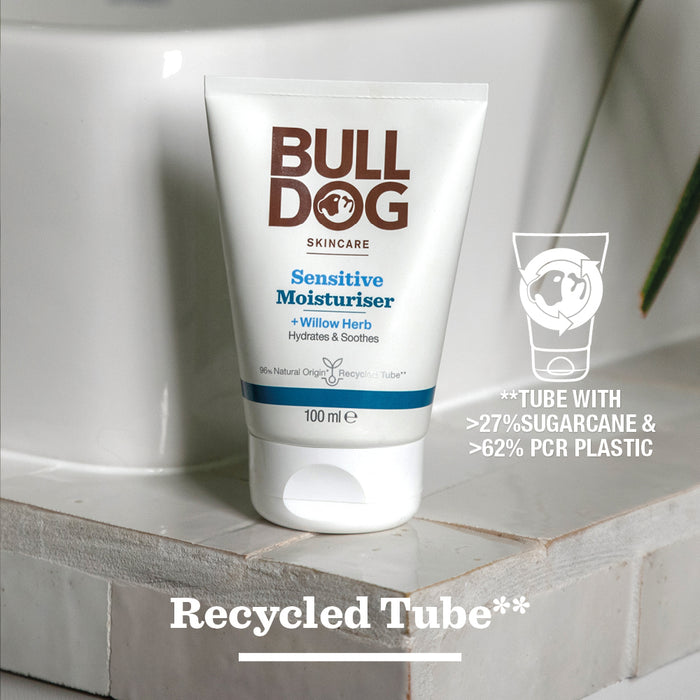 A tube of Sensitive Moisturiser sits on a bathroom counter. The label notes it’s made with 27% sugarcane and 62% PCR plastic, with “Recycled Tube**” below, emphasizing its natural origin ingredients.