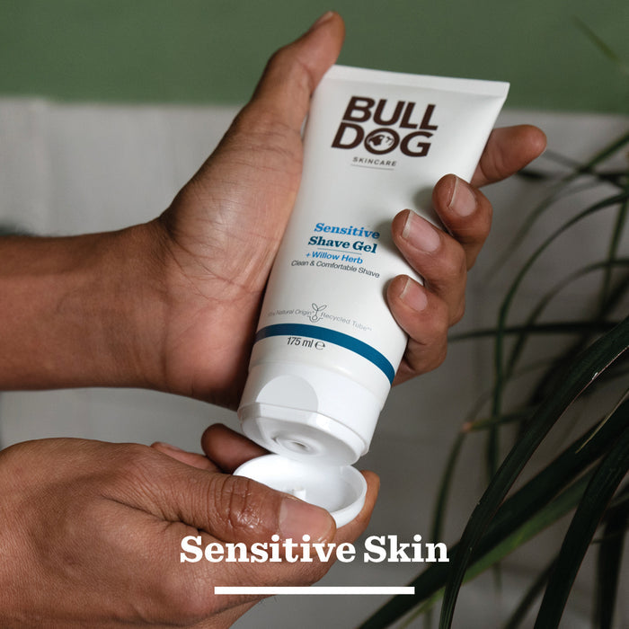 A person dispenses Sensitive Shave Gel for men onto their hand, with the tube labeled for sensitive skin. Text at the bottom reads Sensitive Skin.