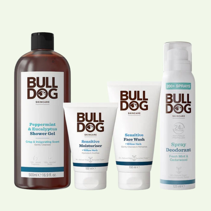 The Sensitive Spray Deodorant Bundle includes a large shower gel, moisturizer, face wash, and spray deodorant—each in white packaging with brown and green text—for an elevated grooming experience.
