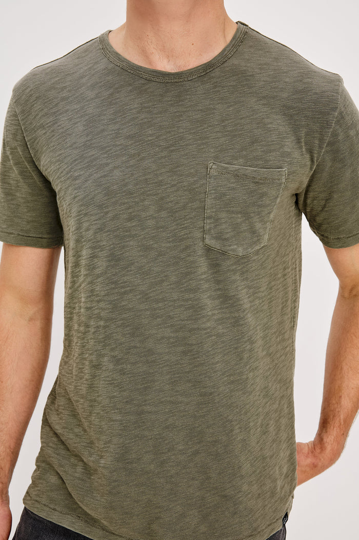 Skipper Short-Sleeve T-shirt with a Crew Neck and a Chest Patch Pocket in Surplus Colorway, a green - Front Detail View Featured on Model