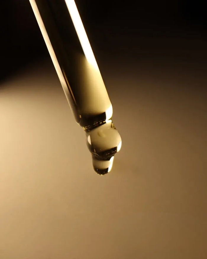 Close-up of a gold pen cap on a dark background