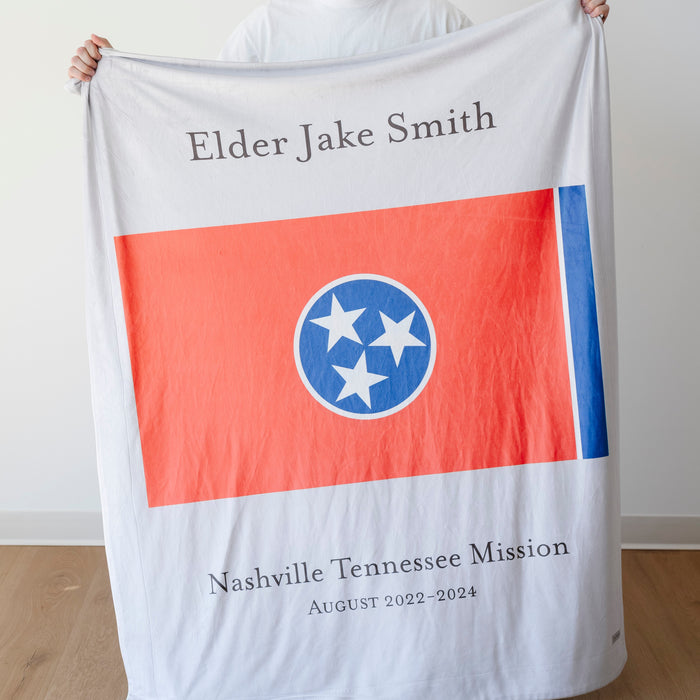 Personalized missionary blanket featuring the Nashville Tennessee Mission flag, missionary name, and custom mission dates.